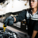 Lexus oil change technician checking dipstick