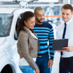 Dealer and customers looking at paperwork